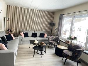 a living room with a couch and chairs at Hausamaarbach in Willingen