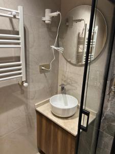 a bathroom with a sink and a mirror at Arkeon Bosphorus Hotel & Suites in Istanbul +44 photos