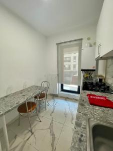 a kitchen with a counter and two chairs in it at Waterfall Studio in Bucharest +1 photo
