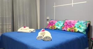 a blue bed with towels on top of it at Casale Parvil in Monteprandone