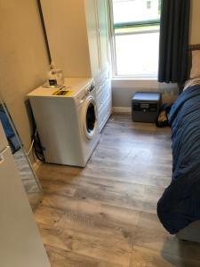 a laundry room with a washing machine on a wooden floor at Country Hideaway For A True Getaway in Montgomery