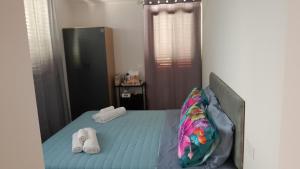 a bedroom with a bed with white shoes on it at Casale Parvil in Monteprandone
