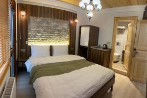 a bedroom with a large bed and a window at Arkeon Bosphorus Hotel & Suites in Istanbul