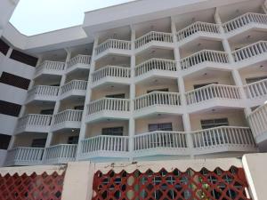 an apartment building with white balconies on it at Raya hotel Nyali Mombasa in Mombasa