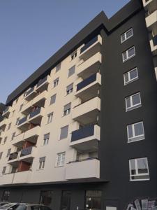 a building with balconies on the side of it at Apartman S52 City Centre in Doboj +5 photos