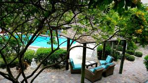 a patio with chairs and a table and a pool at Dolphin Key Resort - Cape Coral in Cape Coral