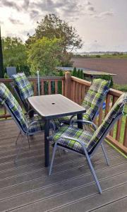 a wooden deck with a table and two chairs at LHMW19A14-FeWo-Seglerfruend-IV in Lemkenhafen auf Fehmarn