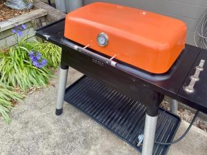 an orange toaster sitting on top of a black table at Kiwi Cove in Tauranga