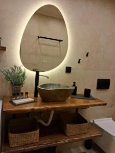 a bathroom with a bowl sink and a mirror at Stella's House Lake Room 2 in Akritochori