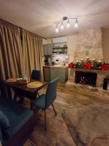 a living room with a table and a fireplace at Stella's House Lake Room 2 in Akritochori