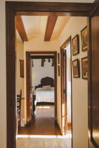 a hallway leading to a bedroom with a bed at Cal Terri Rural in Perafita +76 photos