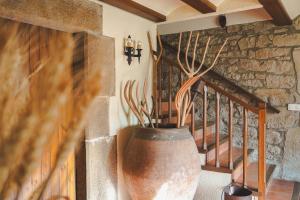 a large vase on a wall next to a staircase at Cal Terri Rural in Perafita