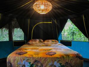 a bedroom with a bed in a tent with a light at Cielo y Tierra in Santa Cruz