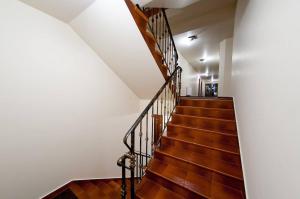 a staircase in a house with wooden floors and white walls at Willa Fox - Wisła Centrum in Wisła +11 photos