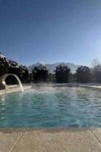 a swimming pool with a fountain in a yard at Casa Csiki in Râşnov