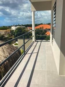 a balcony with a view of a house at Holiday Haven - Jan Thiel in Jan Thiel