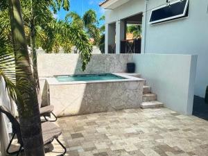 a swimming pool in the backyard of a house at Holiday Haven - Jan Thiel in Jan Thiel