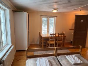 a room with a table and a dining room at Lantlivlodge i Österjörn - Midgård in Jörn