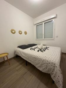 a bedroom with a bed with a black and white comforter at À quelques pas de la gare - RER A in Sartrouville +3 photos