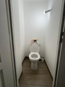 a small bathroom with a toilet with the lid up at À quelques pas de la gare - RER A in Sartrouville