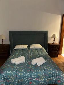 a bedroom with a bed with two pillows on it at Pensão S José-CUNHA'S in Vila Nova de Tazem