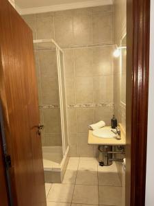 a bathroom with a sink and a shower at Pensão S José-CUNHA'S in Vila Nova de Tazem +39 photos