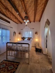 a bedroom with a bed and a wooden ceiling at A historic STONE VILLA with private garden, terrace and private pool just for you in Kyrenia