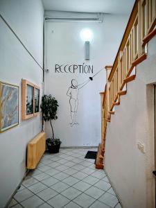 a hallway with a drawing of a person on the wall at U Szermierzy in Wrocław