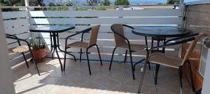 a patio with two tables and chairs on a balcony at Anyrcoy in Viña del Mar