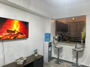 a kitchen with a fire on the wall at EnE Homes in Kisumu