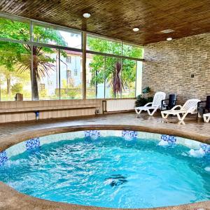 a large swimming pool in a building with windows at Resort Termas de Panimávida - Hotel & Spa in Panimávida