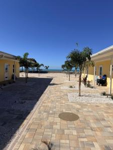 a brick walkway with trees in front of a building at A Beach Retreat on Casey Key in Venice +262 photos
