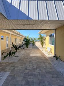 a walkway outside of a building with a blue roof at A Beach Retreat on Casey Key in Venice