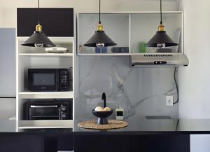 a kitchen with a microwave and a bowl of food at Maridalba 2 in La Coronilla +25 photos