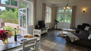 a living room with a couch and a table at Herrenhaus Darbein in Dargun