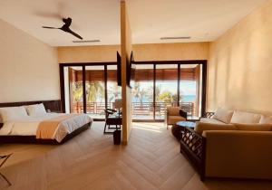 a bedroom with a bed and a couch at Paraiso Rainforest and Beach Hotel in Omoa