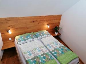 a bed in a room with a wooden head board at Appartement HochOben in Planneralm