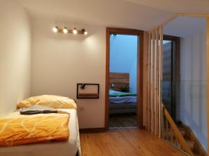 a bedroom with a bed and a sliding glass door at Appartement HochOben in Planneralm
