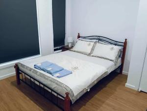 a bedroom with a bed with two towels on it at Northern Retreat in Wallan