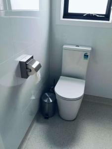 a bathroom with a toilet in a stall with a window at Northern Retreat in Wallan +5 photos