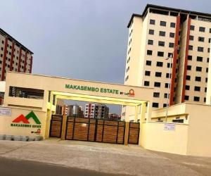 a large building with a gate in front of two buildings at EnE Homes in Kisumu