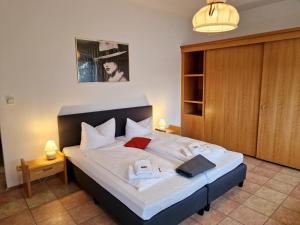 a bedroom with a large bed with white sheets at Bayerischer Wald, FVI Hotel und Restaurant in Neukirchen