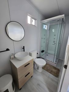 a bathroom with a sink and a toilet and a mirror at Maridalba 2 in La Coronilla