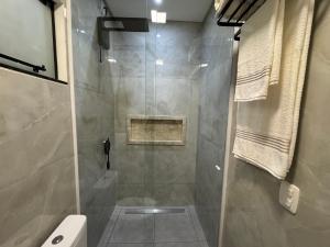 a shower with a glass door in a bathroom at Casa Nova & Aconchegante in São Bento do Sul +25 photos