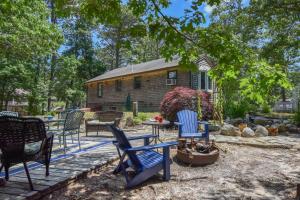 a yard with chairs and a table and a house at 5 Min to Beach Yard w Fire Pit in Wellfleet