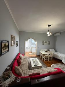 a living room with a couch and a table at Guest house Luli Mucaj in Çorovodë +30 photos