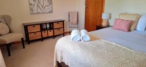 a bedroom with a bed with towels on it at PAK House Central - Spacious 4 Bedroom New Listing! in Echuca