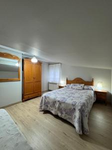 a bedroom with a large bed and two night stands at Apartamentos Casa Alvarina - Luarca in Cortina +30 photos