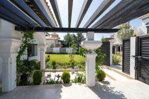 a patio with a black and white pergola at Luxury Villa with Private Pool STR1 in Tangier