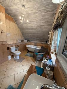 a bathroom with a tub and a toilet and a sink at CHILL Village in Nowinka +86 photos